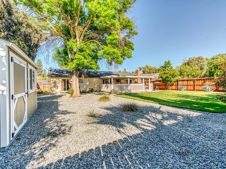 Features granite rocks for easy maintenance in the backyard.