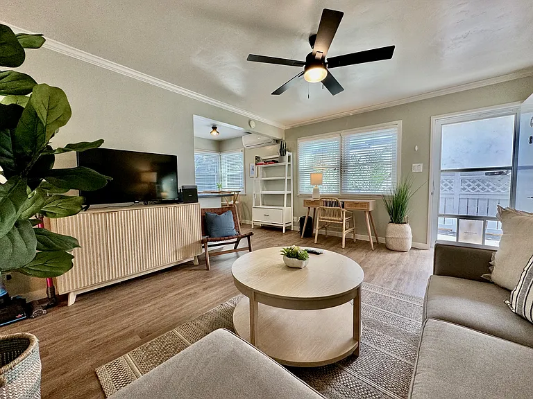 Comfortable living area with workspace, ceiling fan, air conditioning/heater mini split, wifi, and Roku TV with Netflix and Hulu