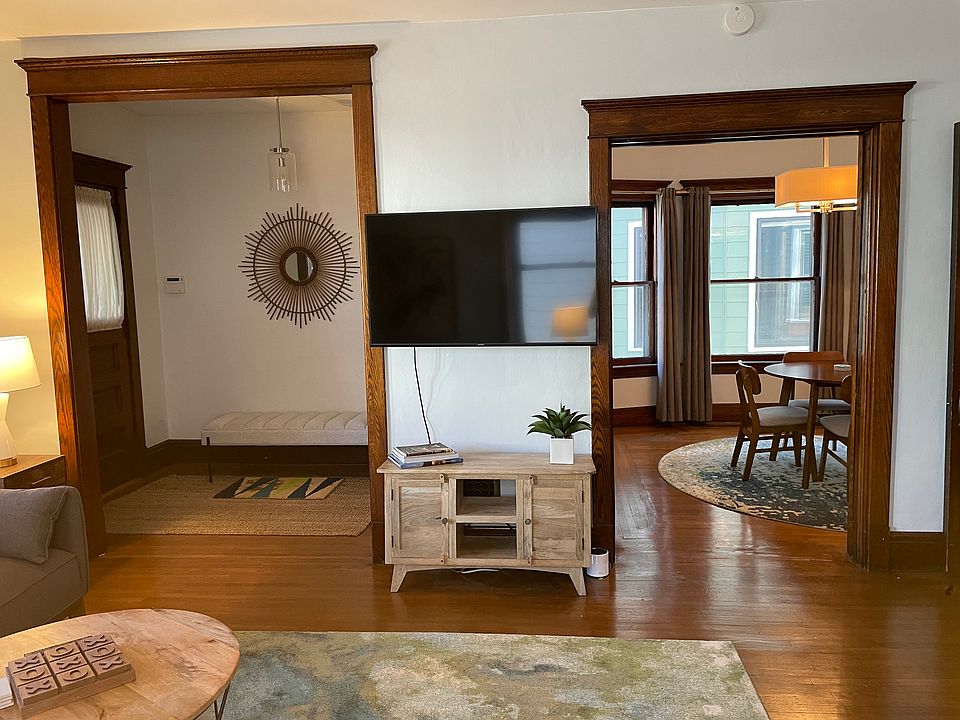 Living room looking into entrance way on left and dining room on the right.