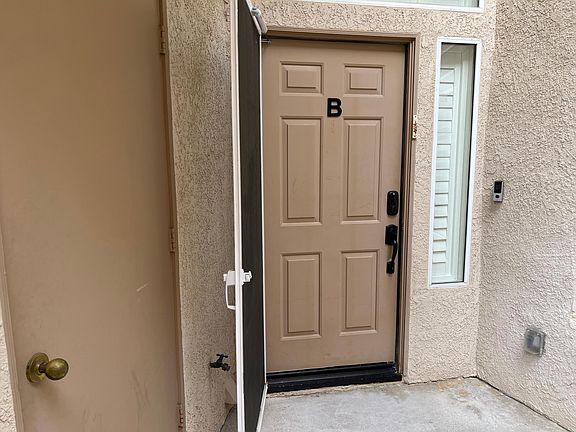Front door and patio. Patio storage area on left side