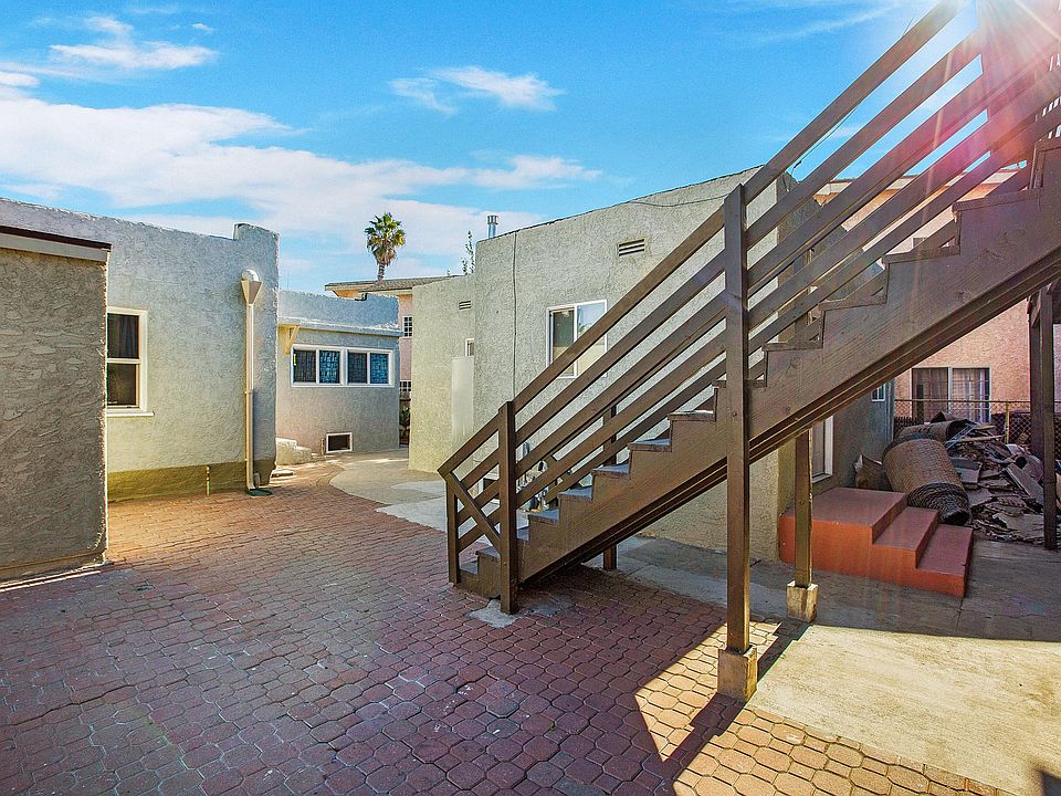 Stairs leading up to back units and laundry room on far left