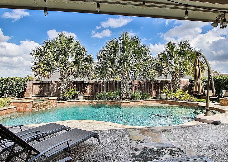 Need a little break from the sun after your swim? No problem! Lounge under the large covered patio area and cool off while enjoying the view of your gorgeous backyard oasis.