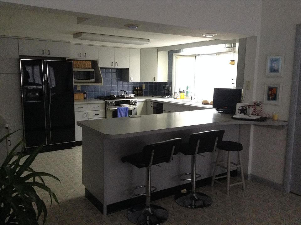 Kitchen has contemporary cabinets, countertops are laminated Formica, plenty of cabinets and drawers, Dish washer, Garbage compactor, & Garbage Disposal included