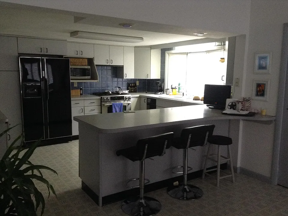 Kitchen has contemporary cabinets, countertops are laminated Formica, plenty of cabinets and drawers, Dish washer, Garbage compactor, & Garbage Disposal included