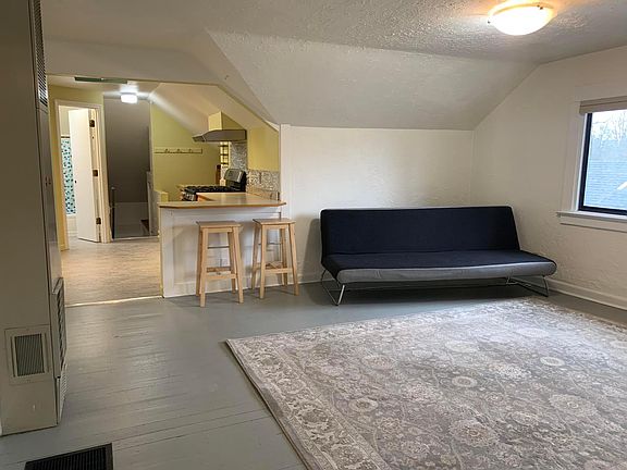 Living room. Rug and stools are included, but futon is not.