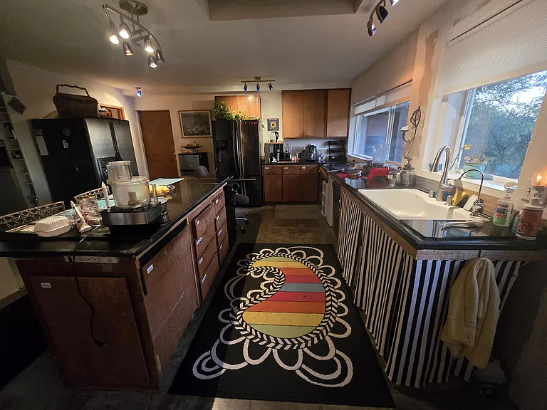 Our Kitchen. It is in the middle stage of renovation. Everything functions and many wonderful meals prepared here. The large space accommodates everyone. There is a door going outside just to the right of the photo.