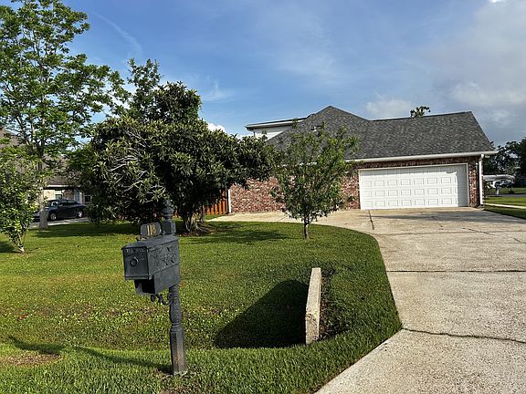 View from mailbox of garage and driveway
