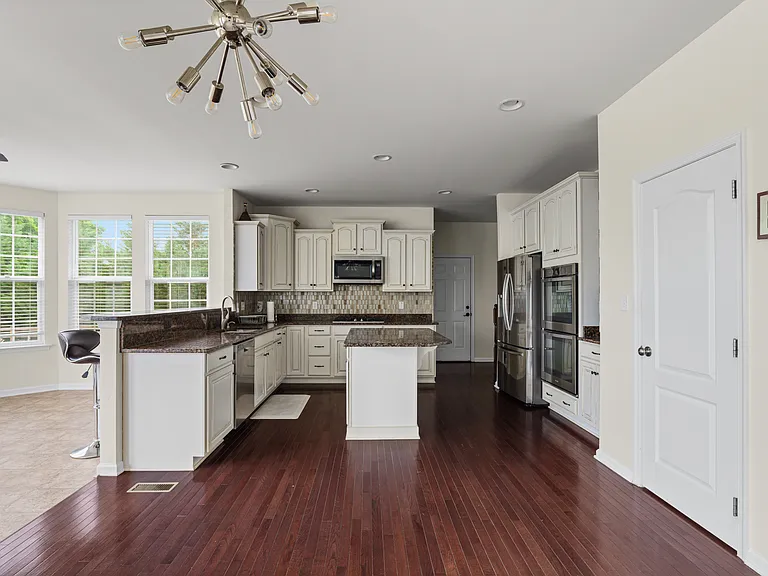 Kitchen with center island and breakfast area slightly shown on the left