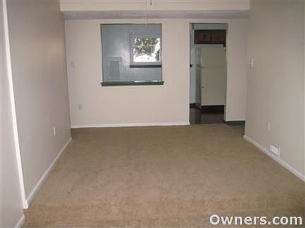 dining area with a ceiling fan, new carpet