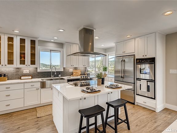 The gourmet kitchen is a chef's delight with all new appliances, a double oven, and a new farm sink with an adjustable faucet. 
