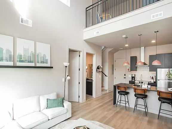 Open concept kitchen + living room with lots of natural light