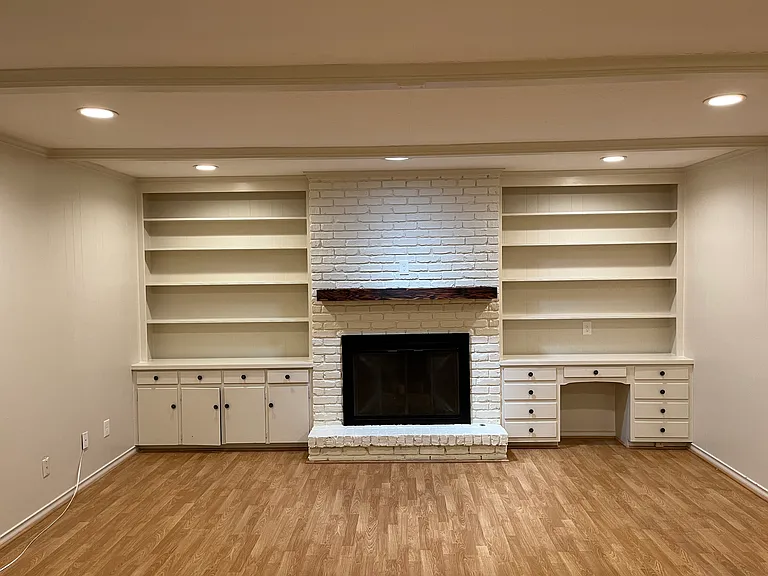 Living room with shelving and gas fireplace
