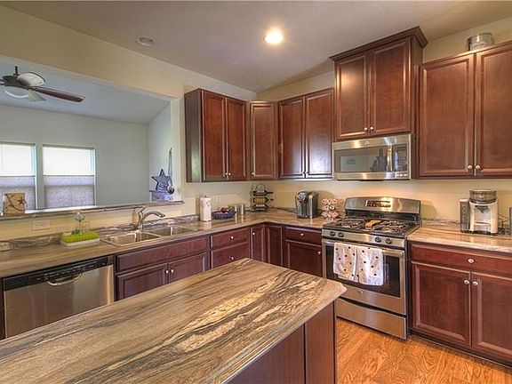 A kitchen even the seasoned chef will appreciate.  It offers upgraded Cherry cabinetry, stainless/black appliances and abundant 