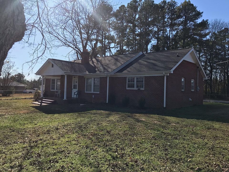 Front of house with woods in back yard and farm land