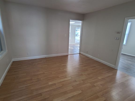 Living room from front entrance
- Entryway to kitchen (left)
- Entryway to bedroom 2 (right)