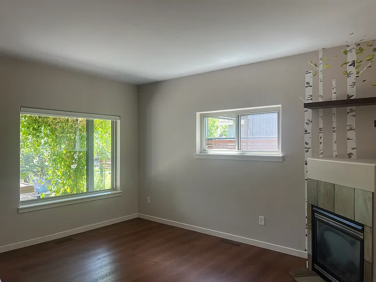 living room with bay window looking out at front garden and yard