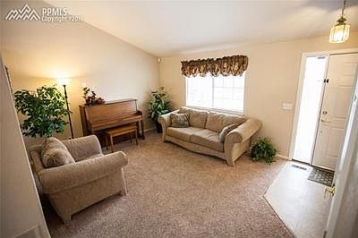 Living room on main floor with vaulted ceilings.