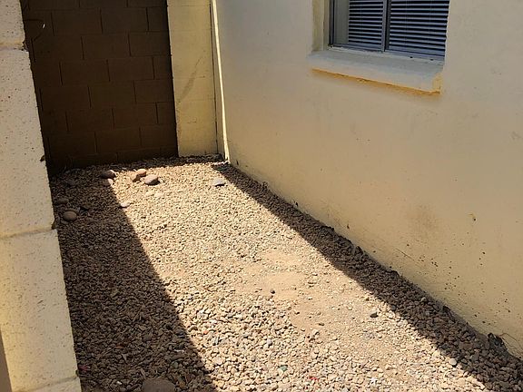 Private Patio Left Side. Come fall once it cools down-the Right side will get pavers for you to put your Bar B Q Grill and or table and chairs. Also the outside wall/fence/gate will be all painted.