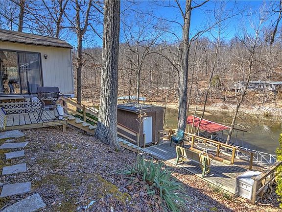 It comes complete with a back yard that has a deck and path leading to the dock.