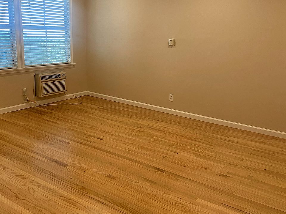VIEW OF LIVING ROOM WITH A.C., CAN LIGHTING & REFINISHED HARDWOOD FLOORS. ALL WINDOWS ARE COVERED WITH FAUX WOOD BLINDS.