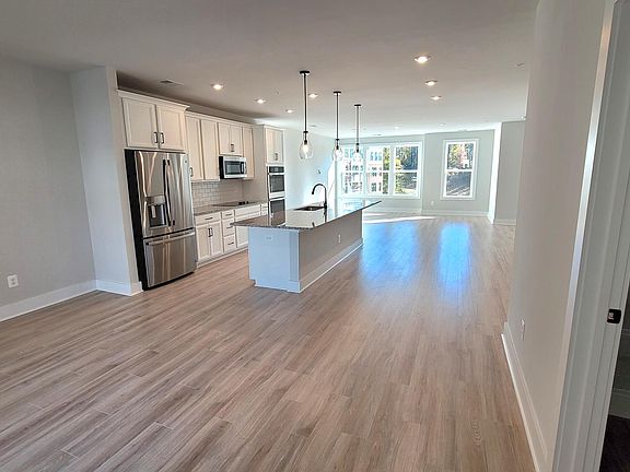 Main floor: living room, kitchen, dining space with a lot of sunlight from huge windows on both sides