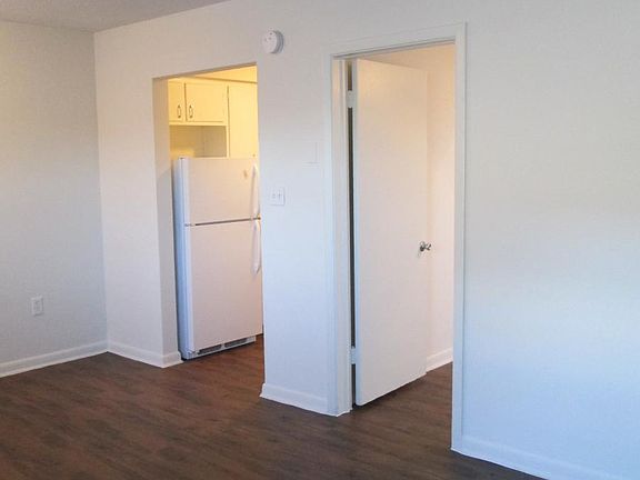 living room showing entrances to bedroom and kitchen