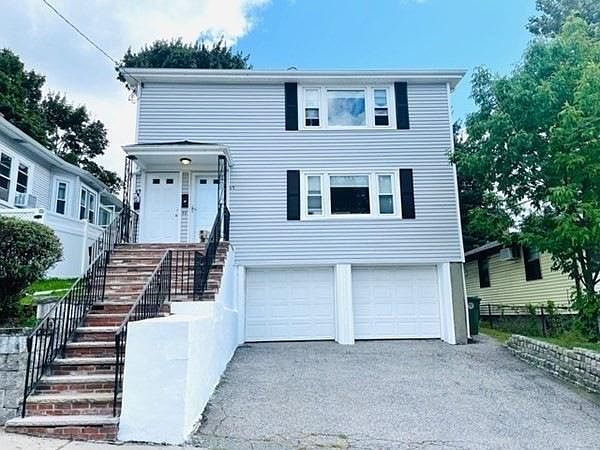 Front view: garage and driveway parking on the left side