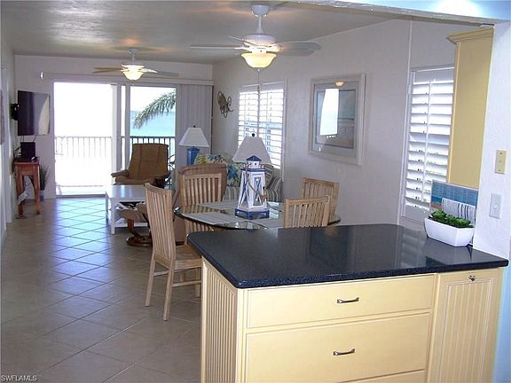 View from front door.   Note neutral tile on diagonal, and updated cabinets, countertops, and Plantation Shutters.