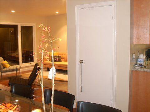 Views from dining room into living room with closet- pantry door.
