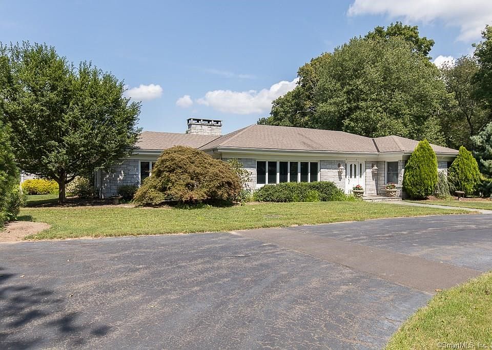 Welcome to 189 Wildrose! A beautiful ranch style home with stone exterior and circular driveway!