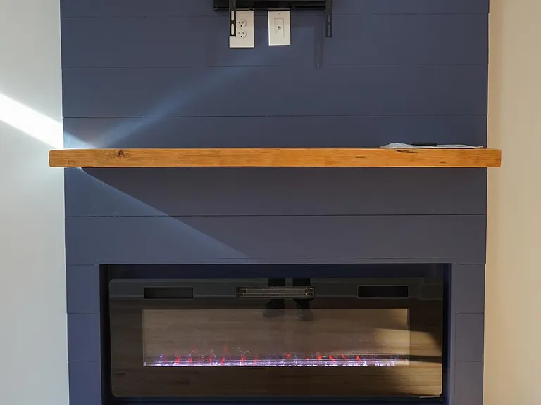 Electric heating fireplace with color changing accents and a built in tv mount