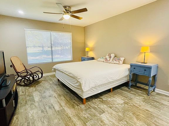 Primary bedroom with a built-in closet offers plenty of room for the king set, side tables, TV, and more.