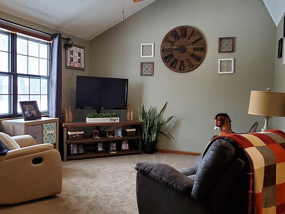 Large living room with vaulted ceiling and ceiling fan