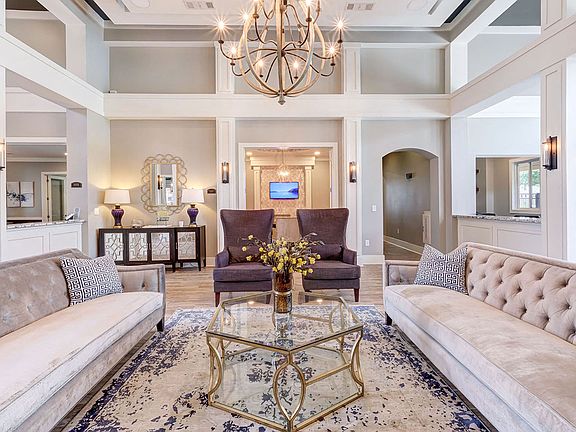 Stunning community lounge with coffee bar, chandelier and plush seating