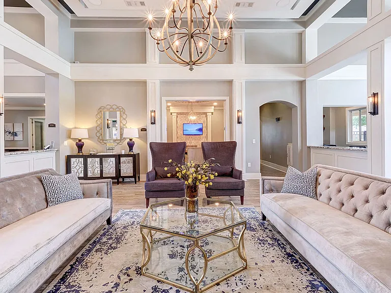 Stunning community lounge with coffee bar, chandelier and plush seating