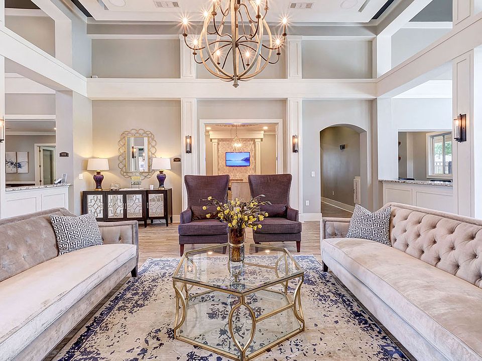 Stunning community lounge with coffee bar, chandelier and plush seating