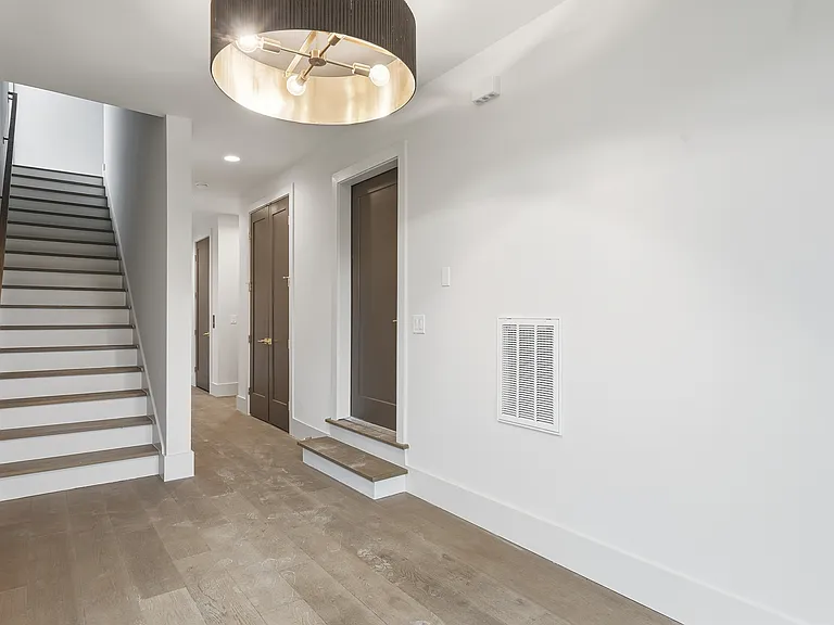 Welcoming entryway with modern staircase and clean design