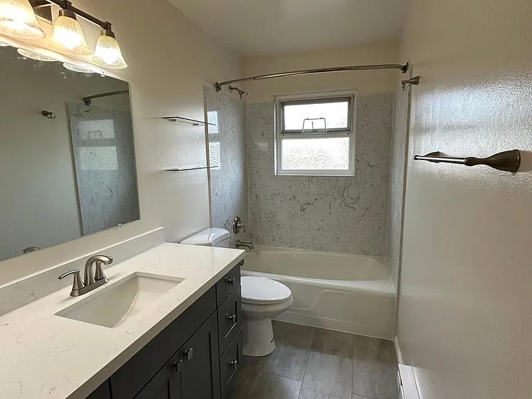 New full bath with Quartz tops and tub/shower surround.