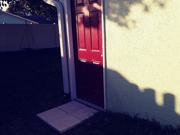 Private entrance with outdoor lighting.