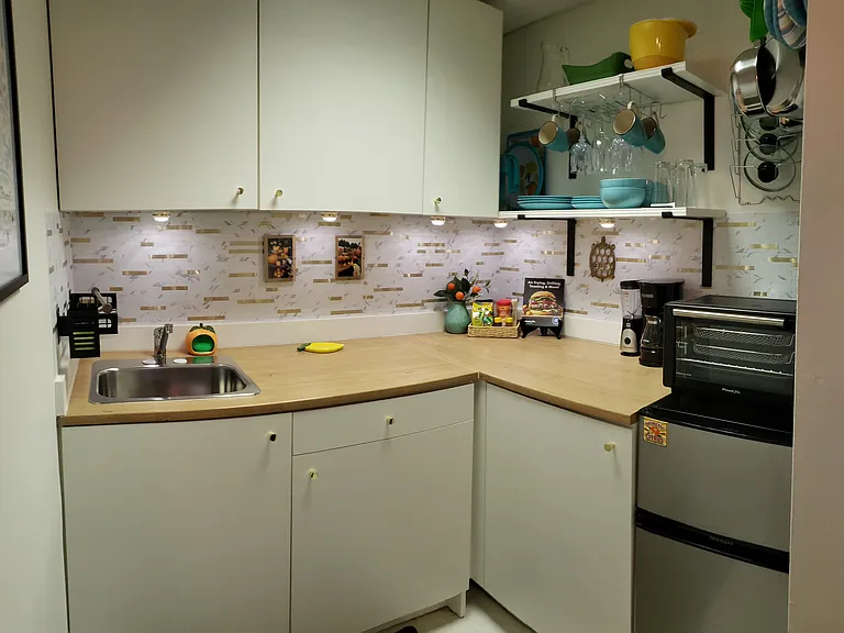 A microwave has since been added. Air fryer, conduction hot plate, electric grill and crockpot are provided as well as cookware.