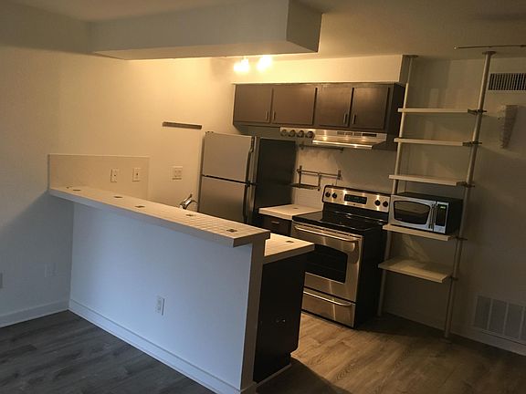 Open floor plan, kitchen bar, stainless steel appliances