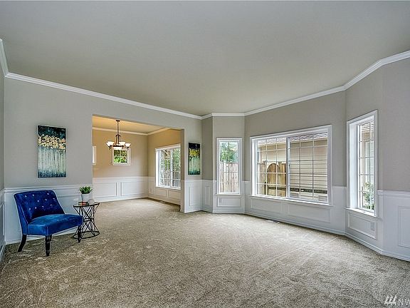 Formal living room off of the entry way, lovely wainscoting detail, beautiful large windows allowing light to pour in.