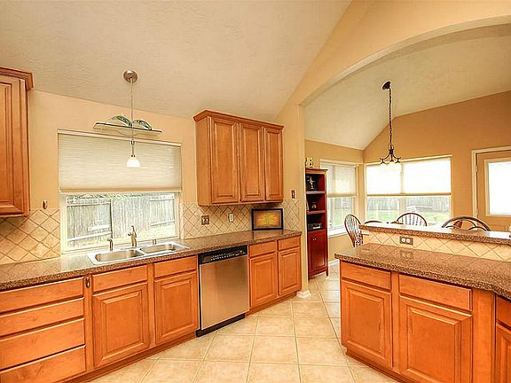 Beautiful window above  your kitchen sink, Silestone counter tops, stone back splash.