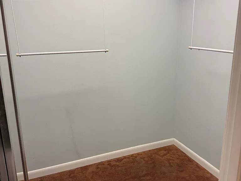 Walk in closet in larger bedroom