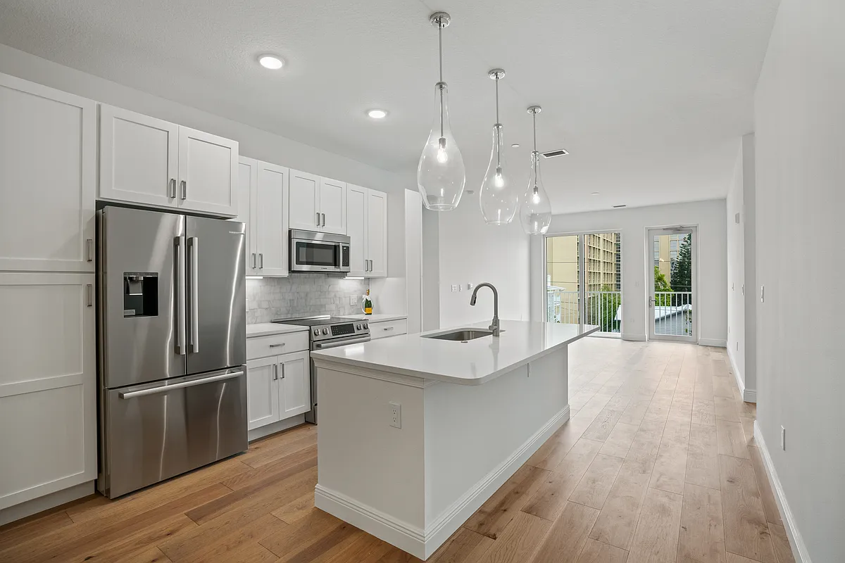 Open concept living, dining, and kitchen area, perfect for entertaining and everyday family living. - 600 3rd Ave S #307
