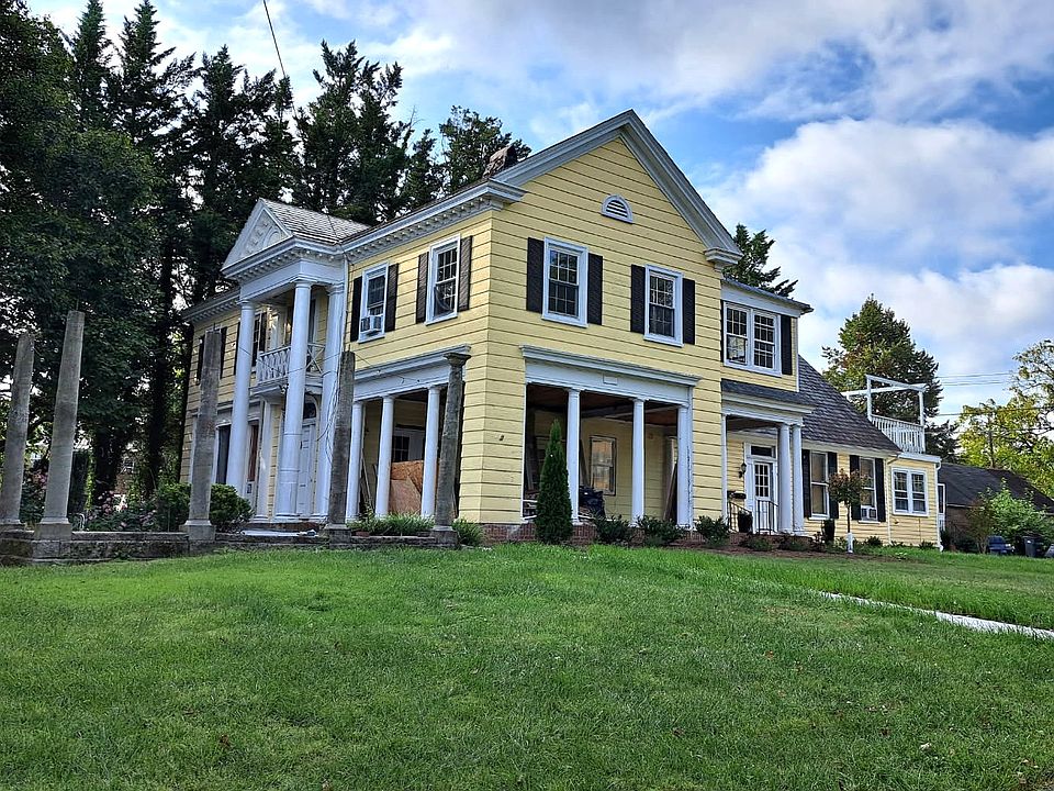 100 year old mansion with 4 apartment residences feature privacy, old school charm and modern updates.
