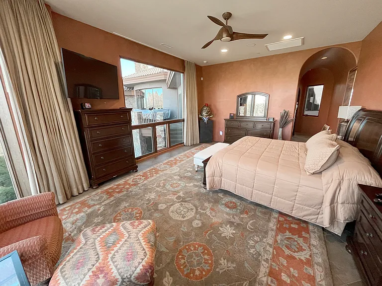 Master Suite 1 with Hall Beyond to Master Walk-in Closet, Elevator, and Kitchen