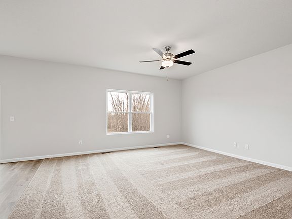 The family room is spacious with a ceiling fan.
