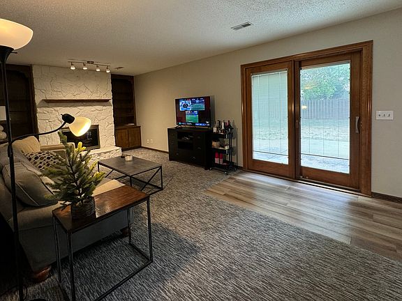 Living room walking out to fenced in backyard.