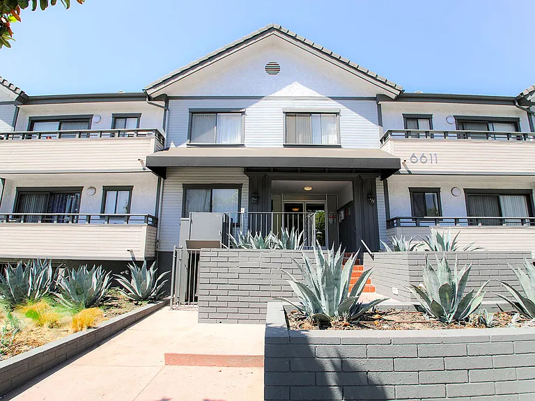 Entrance to Woodridge Apartments with drought tolerant landscape.